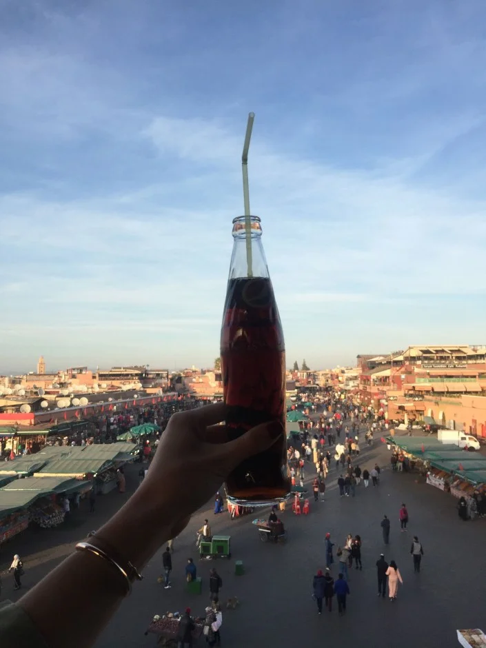 “Some OG Coca-Cola to cool off after hours of navigating the markets. The old-school glass bottles of Coke were everywhere and were referred to as Coke Regular by waiters and vendors. This is at a restaurant overlooking the Jamaa el-Fnaa. It is customary for locals and tourists to sit upstairs in cafés around the center of the market as they drink teas or enjoy a meal before going back into the souk.”