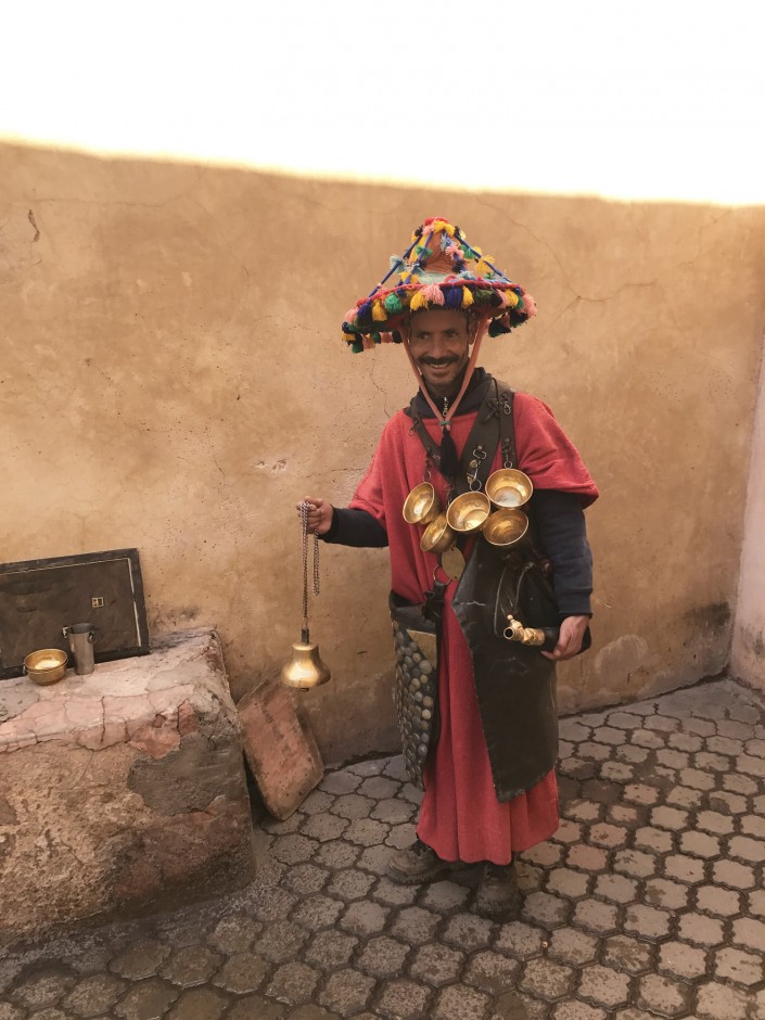  “A new friend outside of the hotel. Our guide told us that he was dressed in traditional Berber attire, and his role in the Medina is to provide water for people throughout the day. Known locally as a fixture and roughly translated into ‘Waterman.’ 