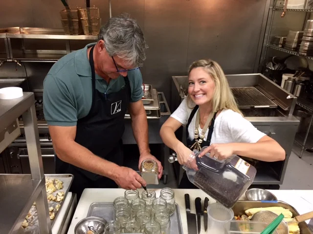 Paul and Katie prepping jars with spices for curry pickled cauliflower 