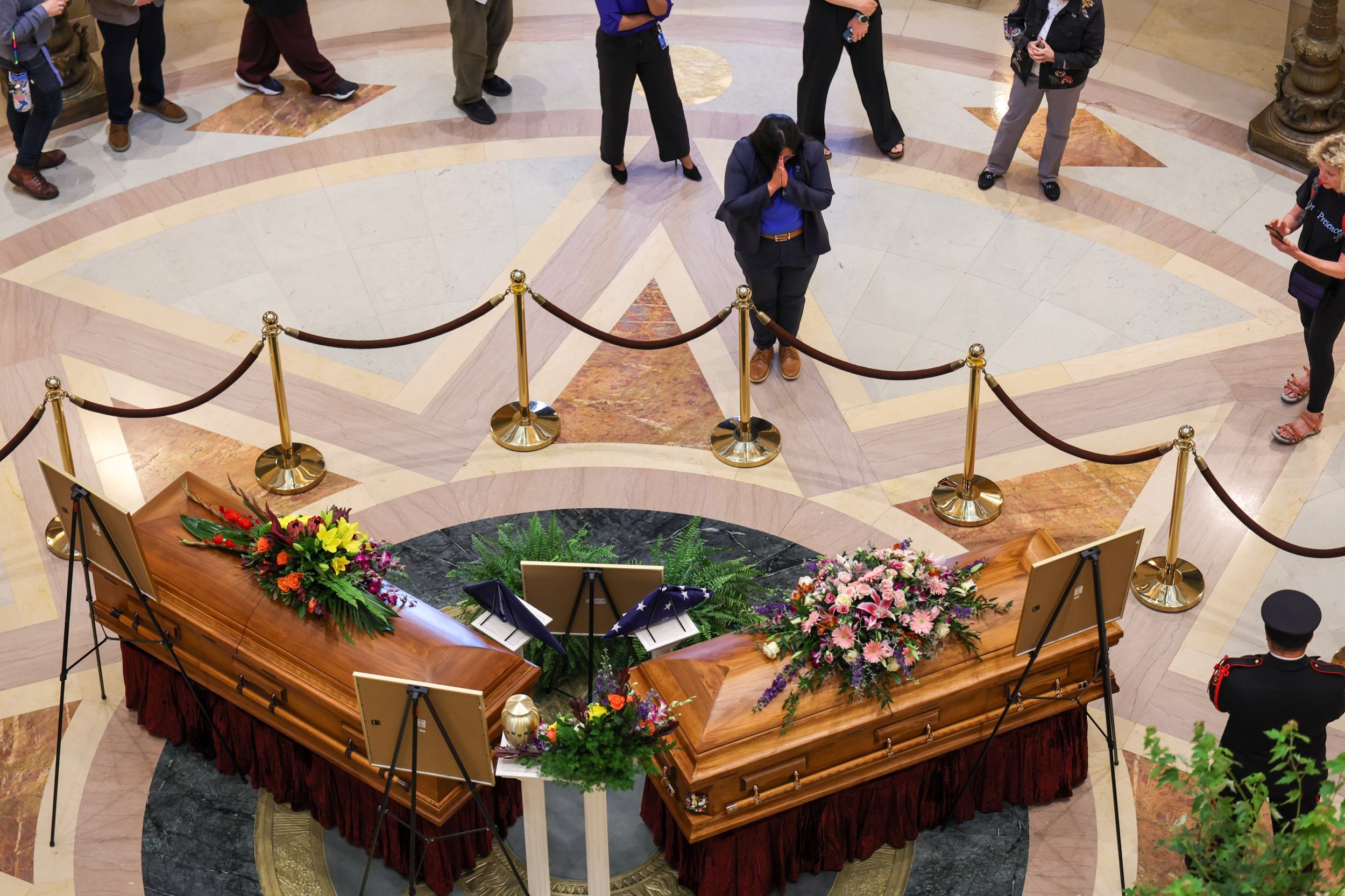ST. PAUL, MINNESOTA - JUNE 27: Members of the public look on as DFL Rep. Melissa Hortman, her husband Mark Hortman, and their dog Gilbert lie in state in the rotunda of the Capitol building on June 27, 2025 in St. Paul, Minnesota.