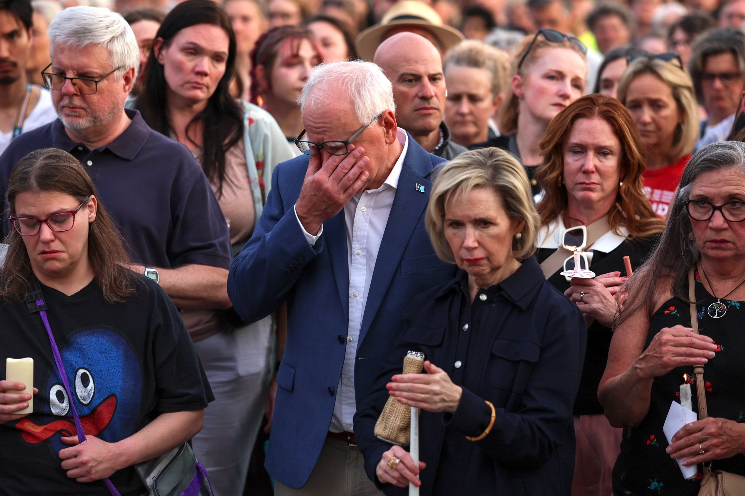 ST PAUL, MINNESOTA - JUNE 18: Minnesota Gov. Tim Walz and first lady Gwen Walz attend a candlelight vigil outside the state Capitol building in St. Paul, Minnesota on June 18, 2025 in St. Paul, Minnesota.