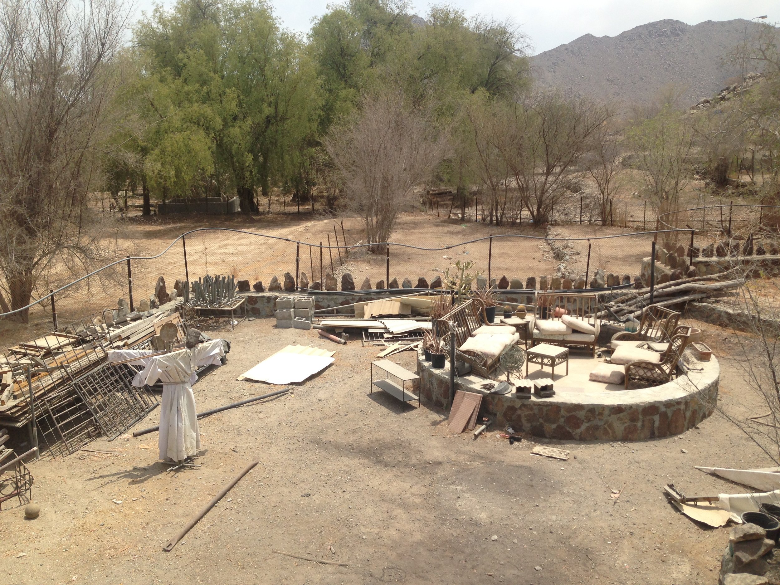 A scarecrow and other objects in the garden of Abdullah Al Saadi's studio. Image by Anna Seaman