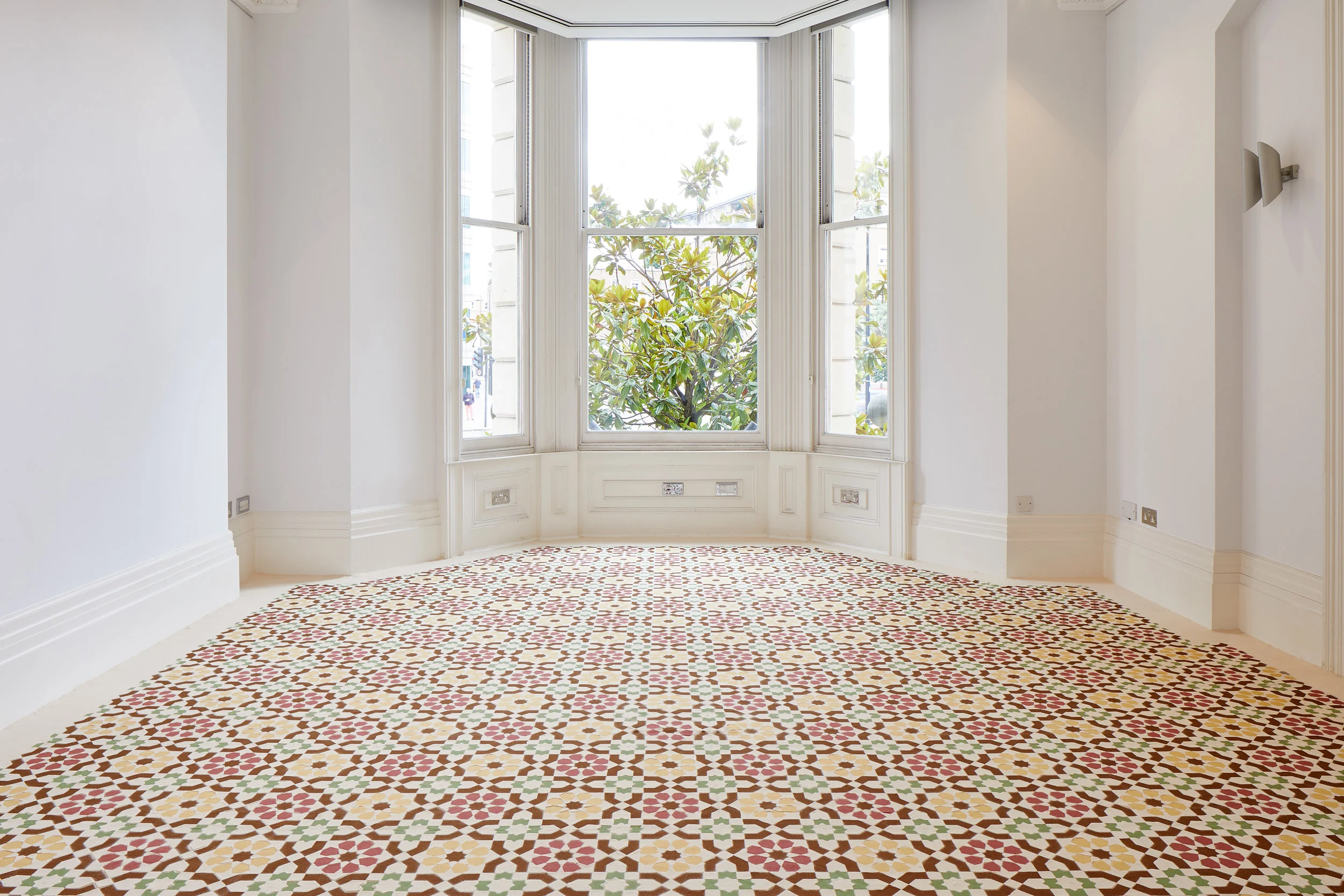 I went away and forgot you. A while ago I remembered. I remembdered I'd forgotten you. I was dreaming. Installation of hand dyed sand (2017) by Dana Awartani. Photo by Andy Stagg. Courtesy of The Mosaic Rooms.