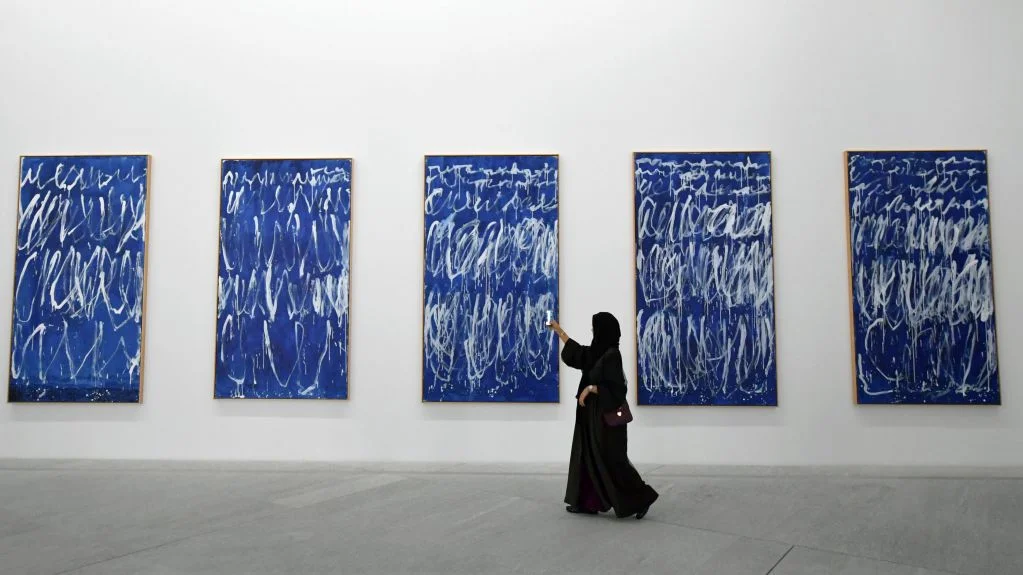 A visitor peruses the Cy Twombly paintings inside the Louvre Abu Dhabi. Image taken by Giuseppe Cacace