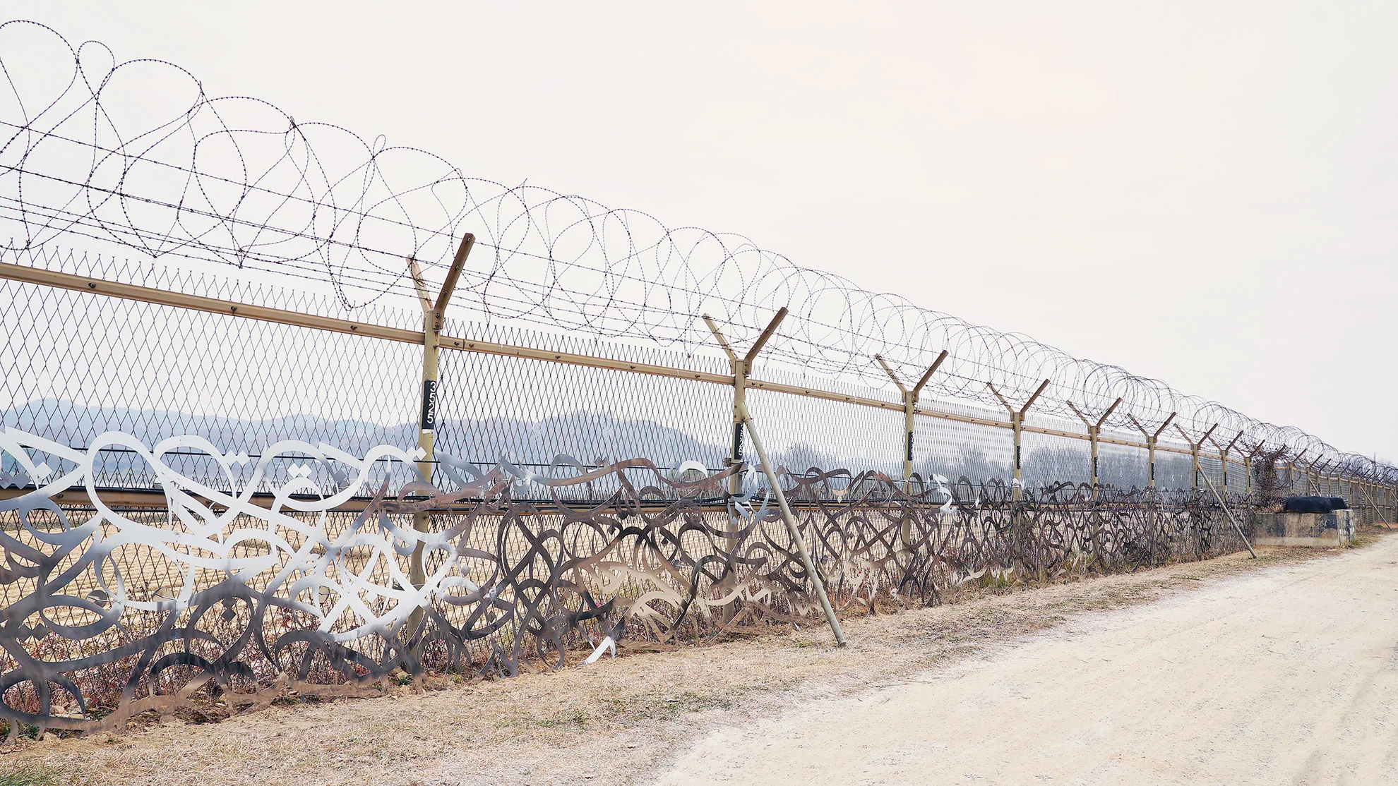eL Seed's artwork that has been installed on the fence between North and South Korea in the Demilitarised Zone (DMZ). Courtesy of eL Seed.