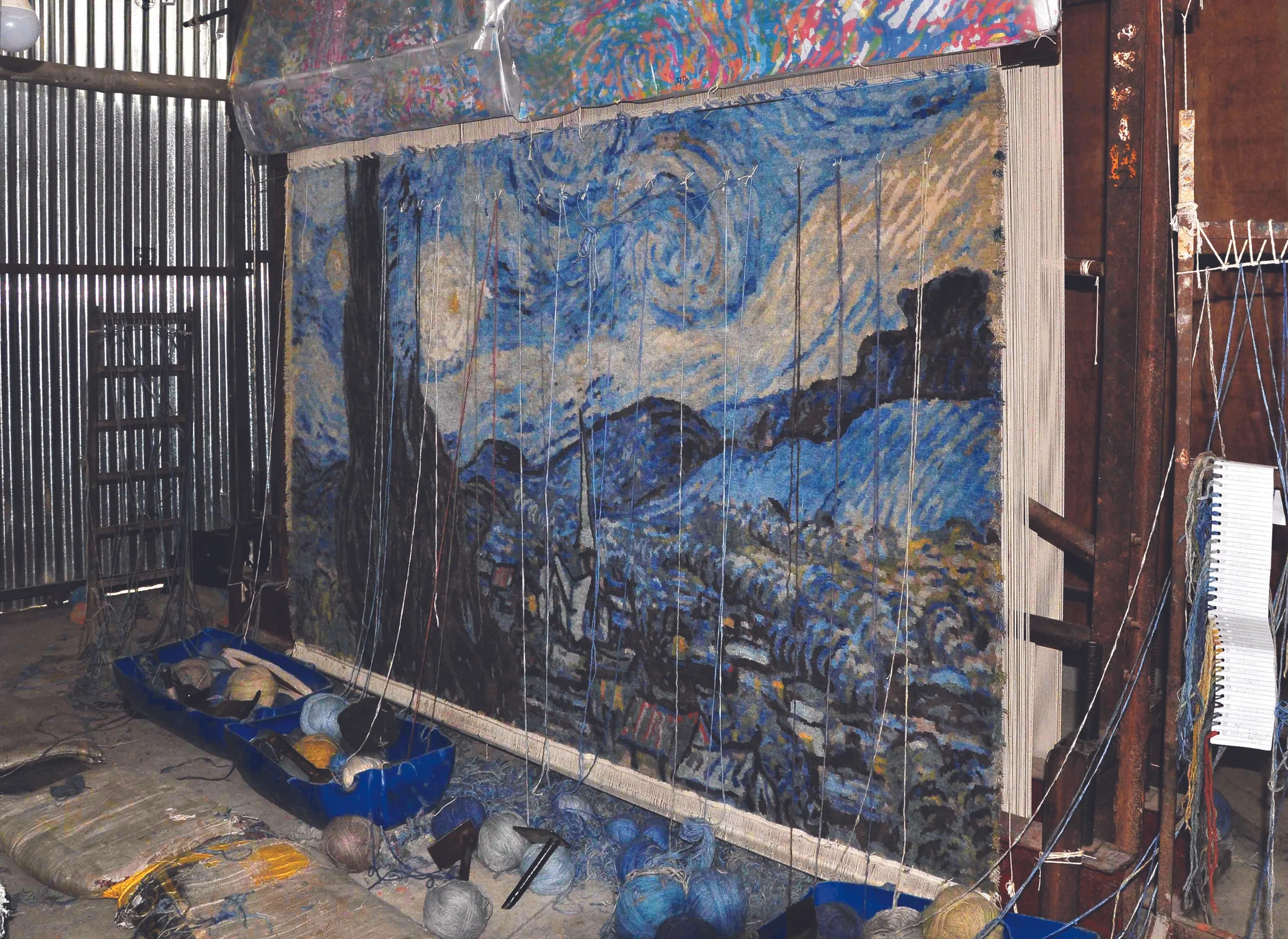 The Starry Night as rendered in hand-woven Tibetan style carpet in its finishing stages. The textile creation will be sold during a silent auction as part of Dubai Art Season. Image courtesy of Samovar Carpets. 