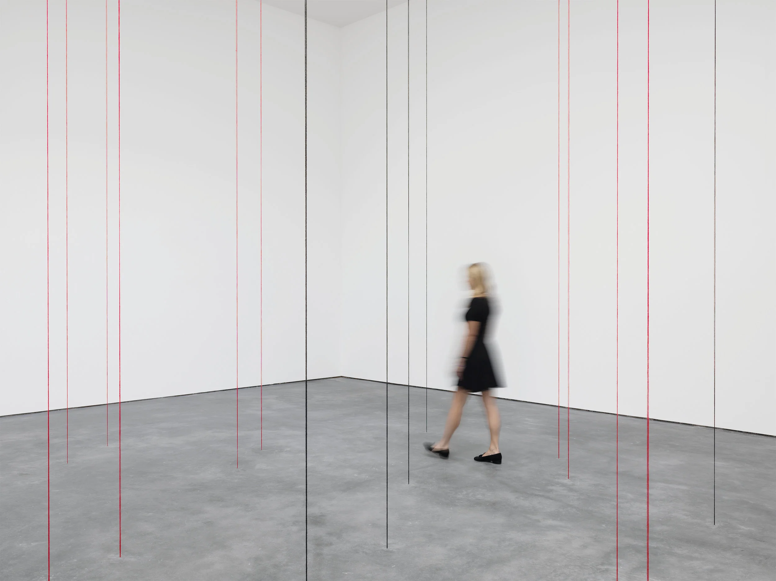 Fred Sandback. Untitled (Sculptural Study, Twenty-two-part Vertical Construction) 1991-2016, black and red acrylic yarn, dimensions variable. The Estate of Fred Sandback. Courtesy David Zwirner