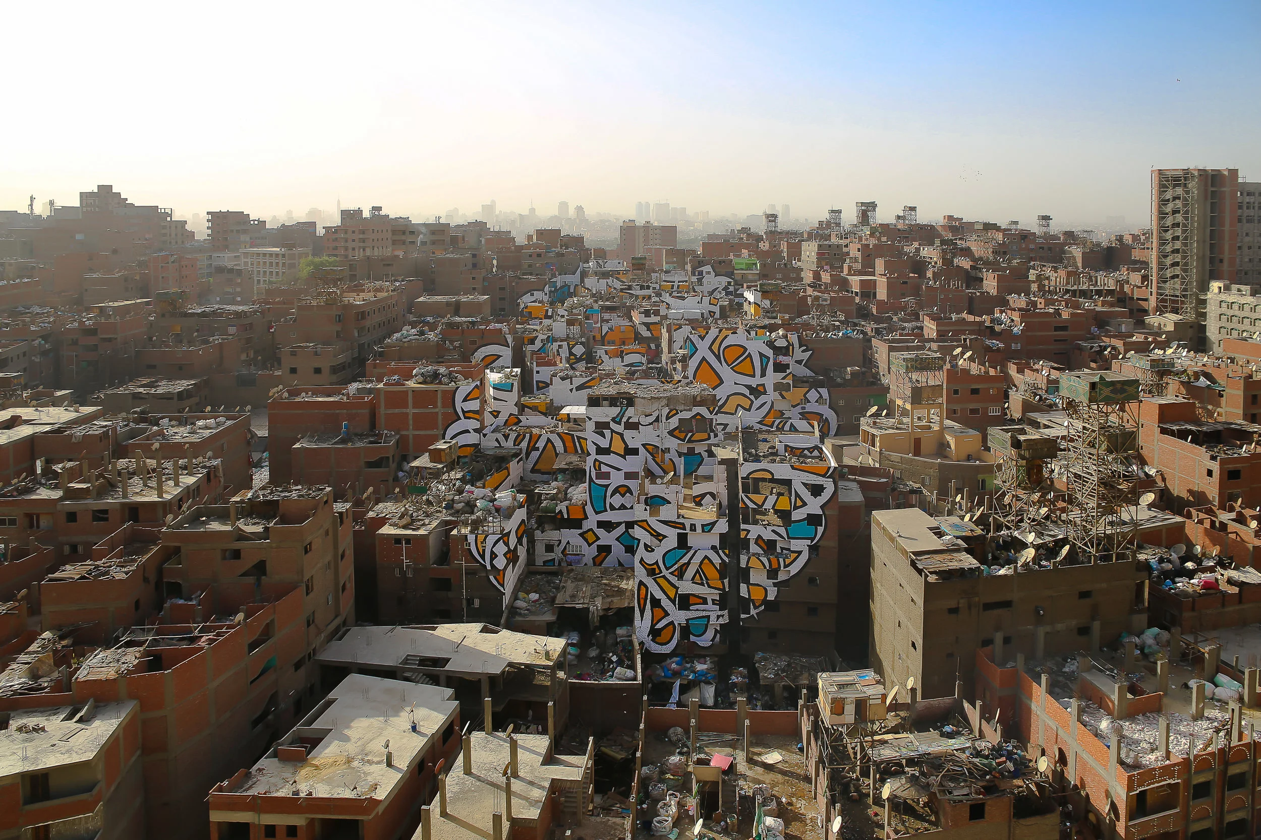 Perception in Cairo’s Manshiyat Nasr district was an anamorphic mural painted over 50 buildings and visible from only one viewpoint. Courtesy eL Seed