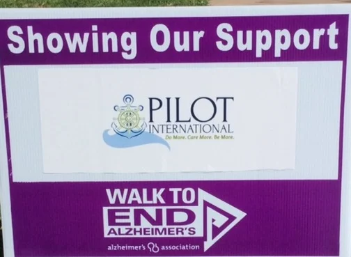 Pilot International logo on a Walk to End Alzheimer's sign.