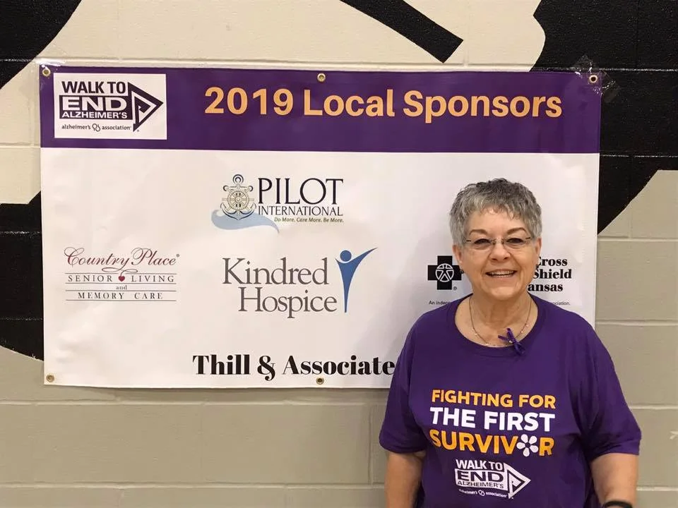 Co-captain of Pilot Club of Great Bend team, Betty Schneider, stands in front of the banner with the names of the donors for the Alzheimer’s Walk. She is wearing this year’s shirt for the fight against Alzheimer’s. The Pilot team surpassed their goal of raising $1,000 for Alzheimer’s. Great Bend Pilot Club is a major sponsor of the Walk to End Alzheimer’s for the past 5 years.
