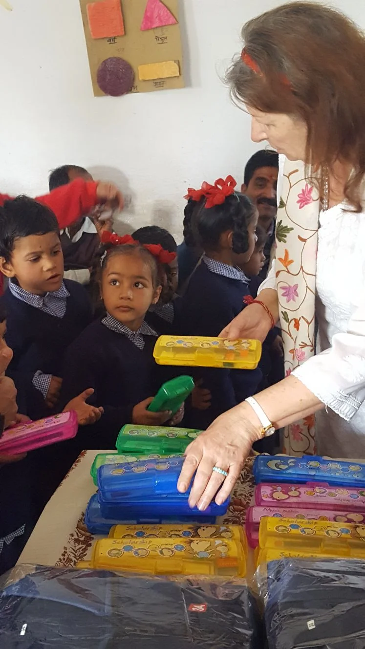 Padma giving out school supplies.