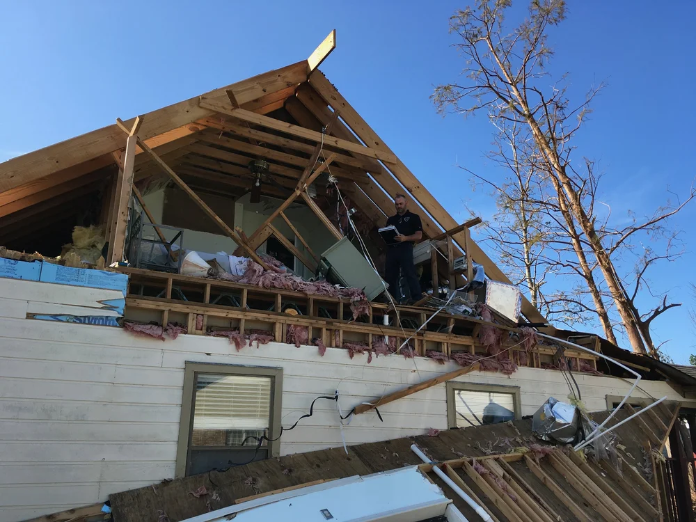 Lance Petrie of VIP Adjusting inspecting a home torn open by Hurricane Michael in Panama City, 2018
