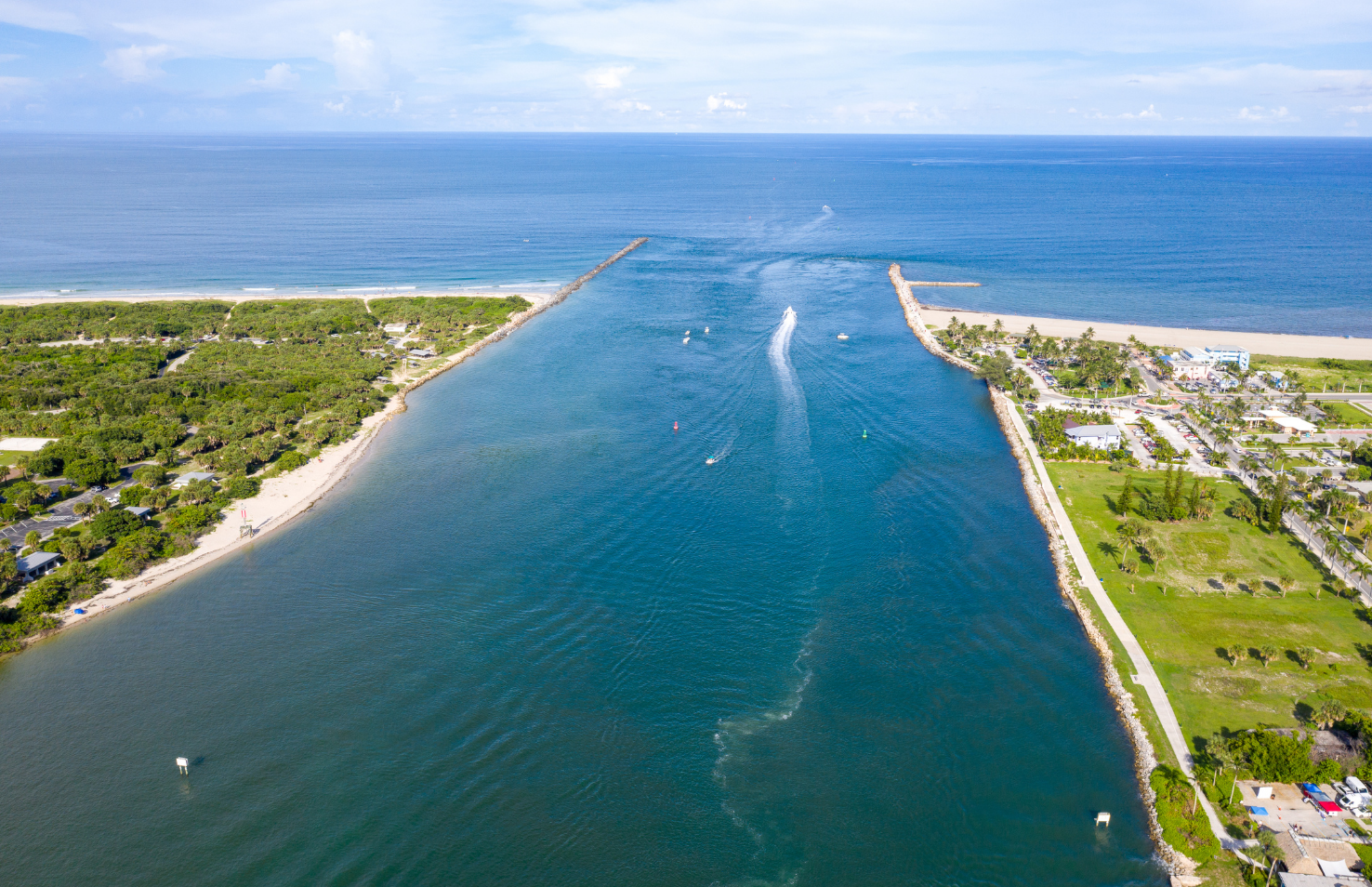 Aerial view of boats entering Fort Pierce Inlet between the beaches and waterways of Florida’s Treasure Coast.