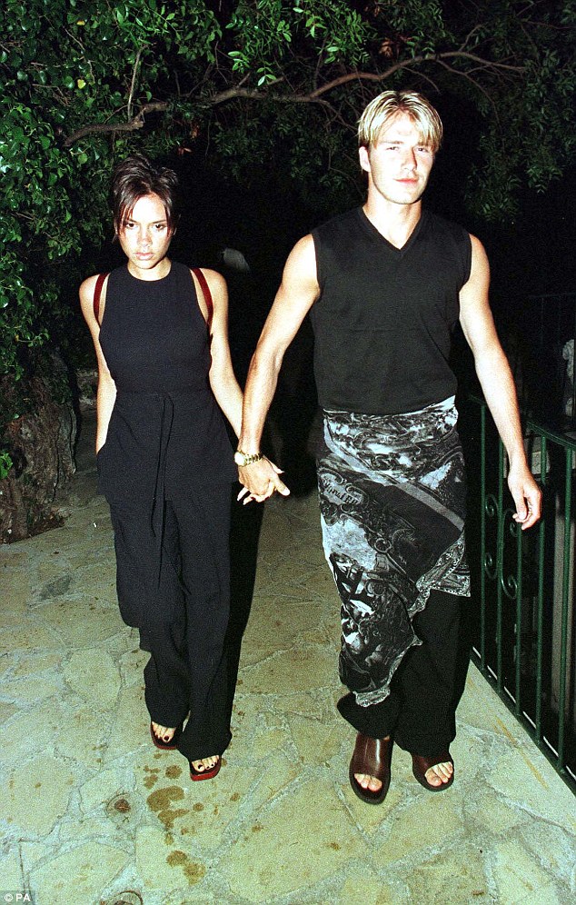 David Beckham rocking a skirt and Victoria wearing the pant-suit.