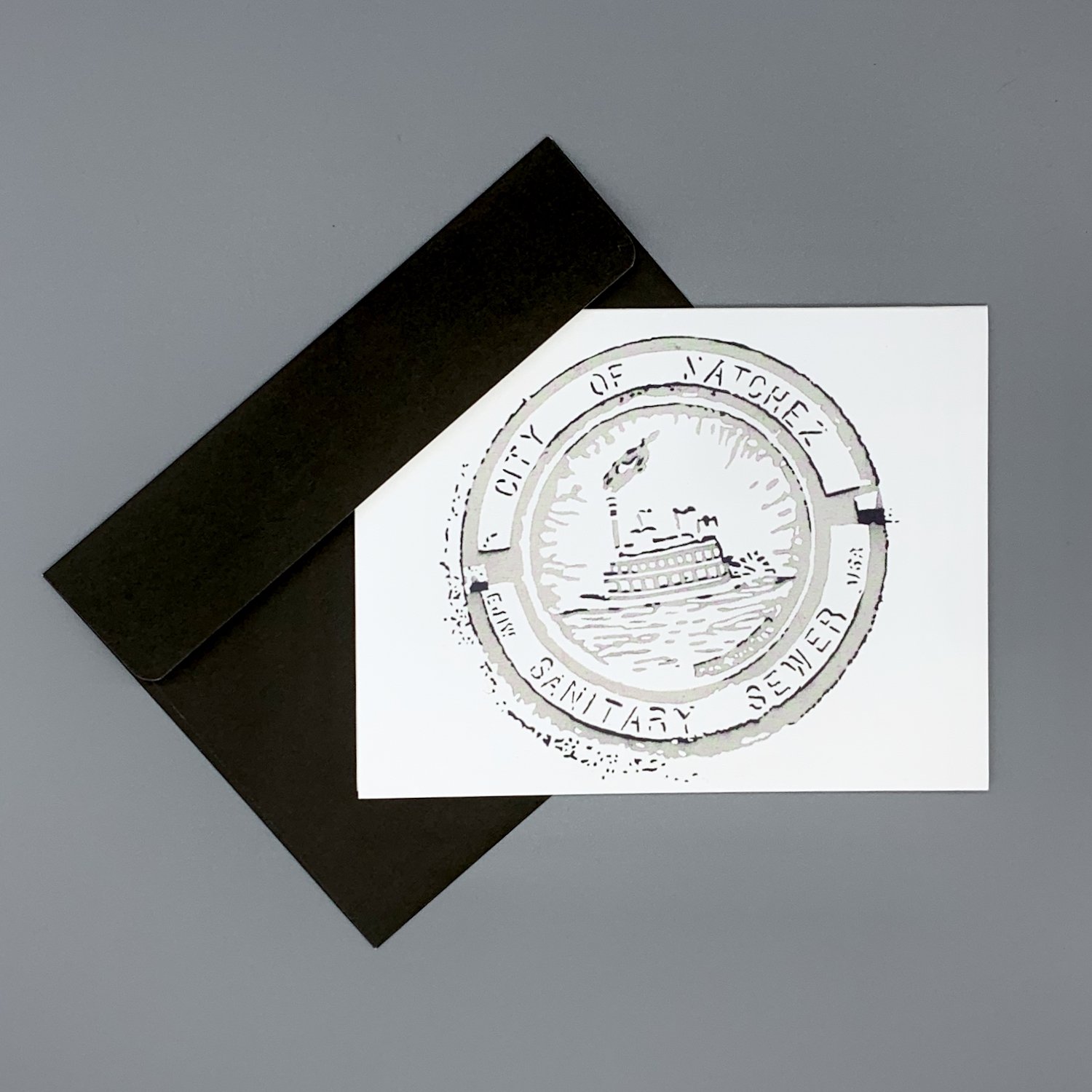 merch-manhole2-notecard-envelope-black.jpeg