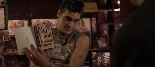 Joaquin Phoenix reading Truman Capote’s In Cold Blood (1966) in sex shop; from Joel Schumacker’s 8mm (1999).