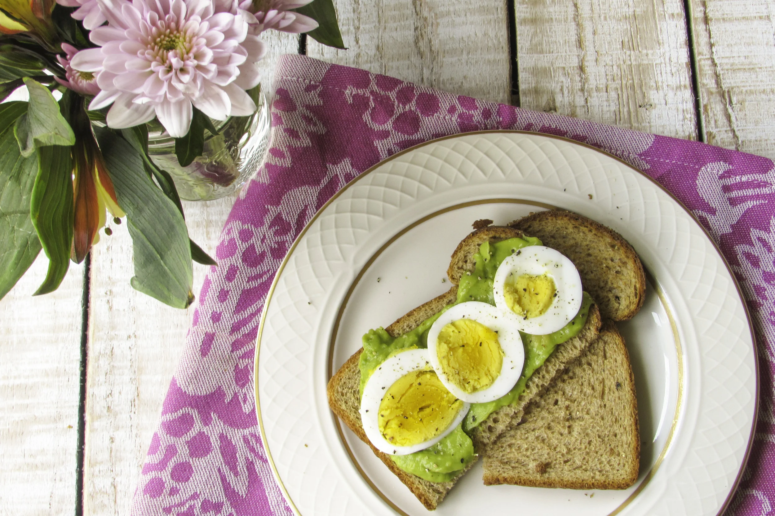 Guacamole, hard-boiled egg slices and fresh ground black pepper