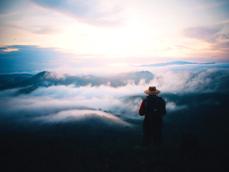 Single-origin coffee subscription image of a man on top of the world looking over blue mountains.jpg