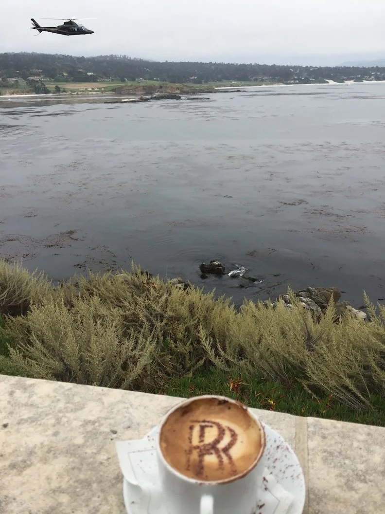 Conscious Bean Latte overlooking the Pacific with a helicoptor at Concours d'Elegance Pebble Beach from the balcony of Rolls-Royce Villa