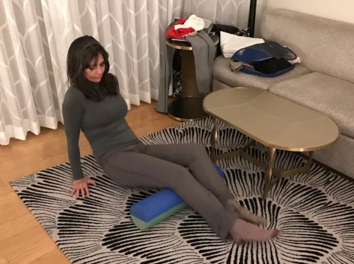Easing the strain of travel, foam rolling in a hotel room.