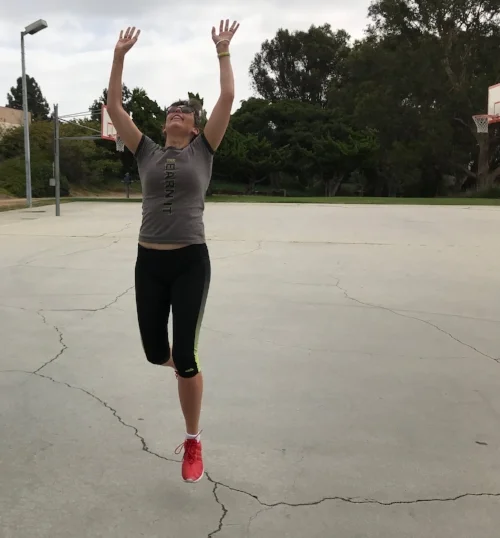 Leaping to shoot basketball in the park.