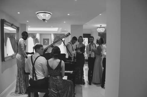 Guests by the grand piano.