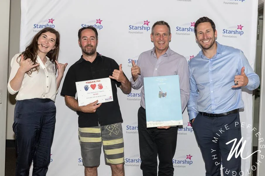 Kent and Juan handing over the money raised in 2016 to Brad and Krissy from Starship Foundation 