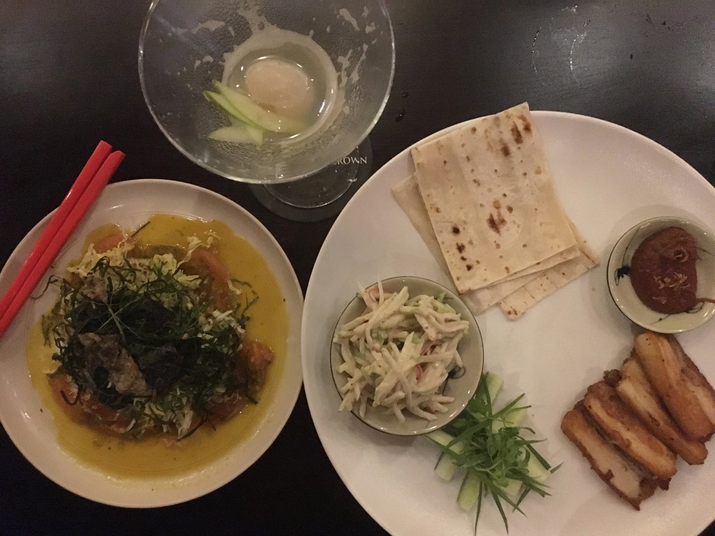 Salmon sashimi, with citrus, coconut and orange dressing, herb salad, crispy nori, shredded cabbage and crispy fish skin. Sliced pork belly, soft tortilla wrap, served with a spicy, plum and tomato jam, Asian coleslaw and cucumber and spring onion.