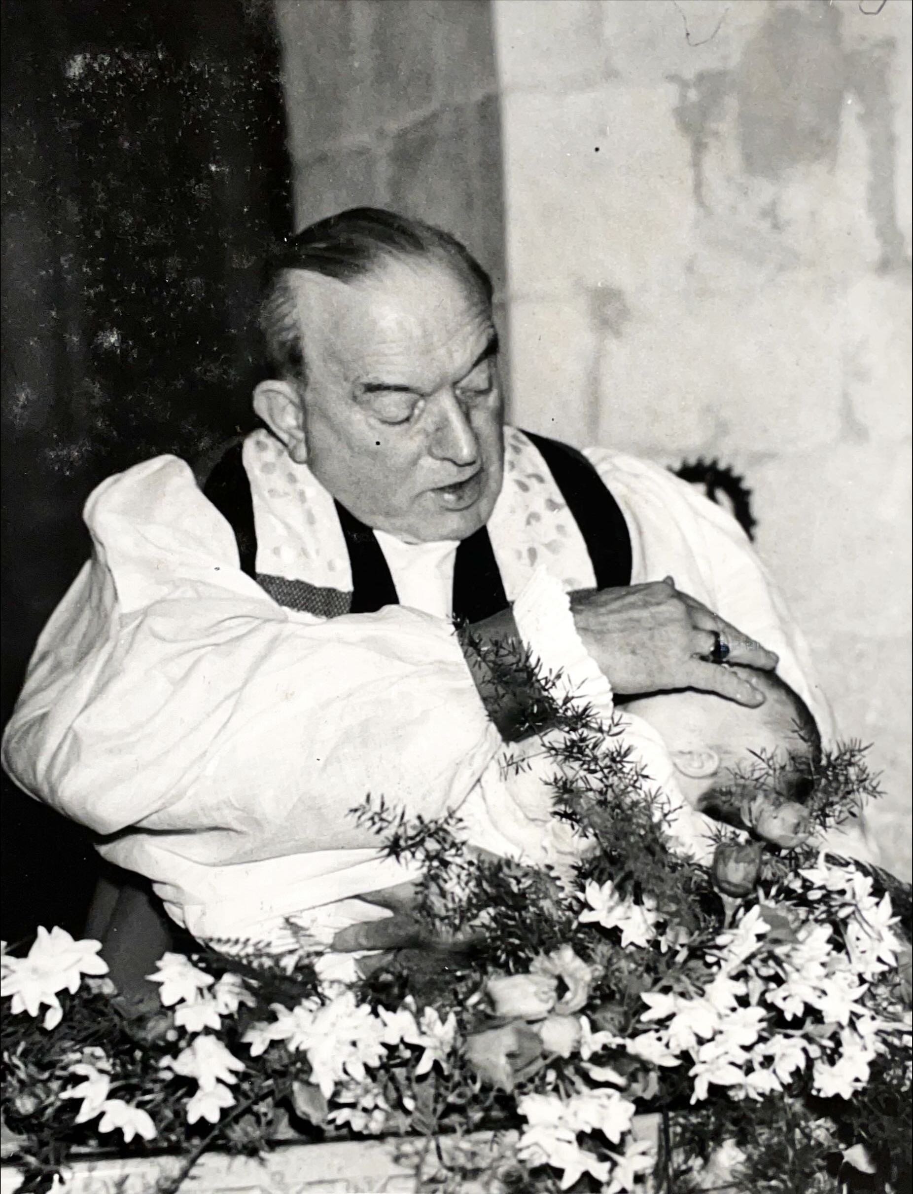Bishop Chavasse baptizing his fifth grandchild, December 1958