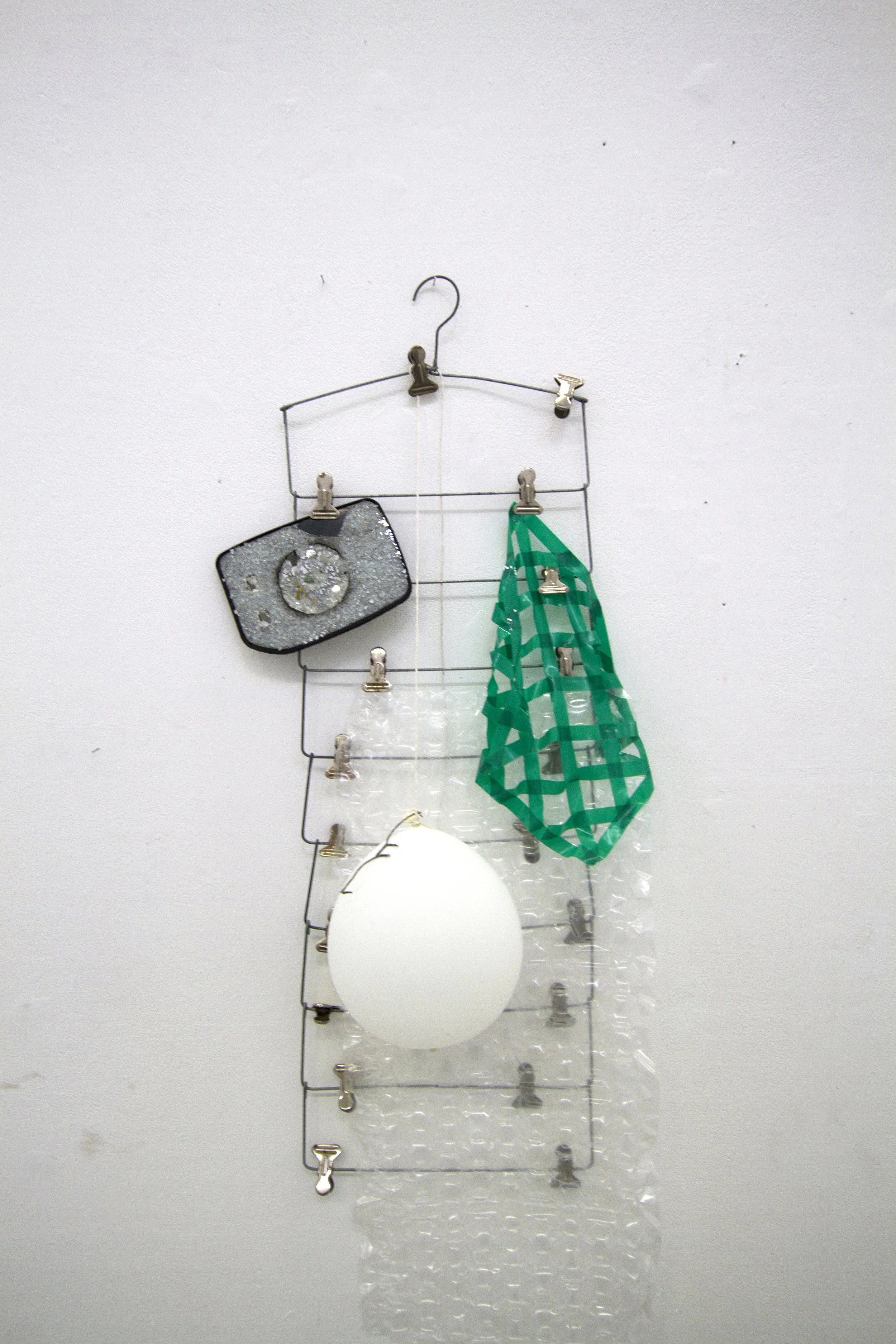 Untitled, steel hanger, insulating tape, LED balloon, bubble wrap, glasses and broken mirror, 92 x 43 x 9 (cm), 2016