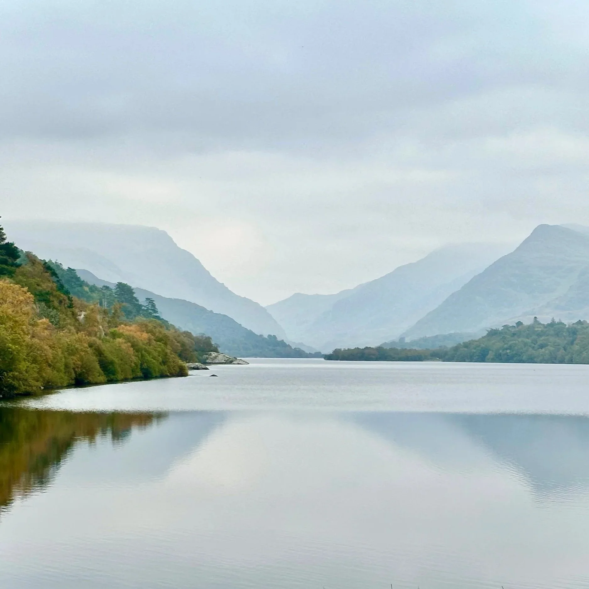 A calm lake surrounded by mountains in North Wales