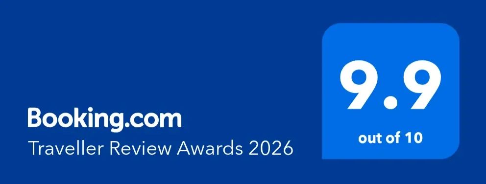 A blue rectangle with text saying BOOKING.COM TRAVELLER AWARDS 2026 and a score of 9.9