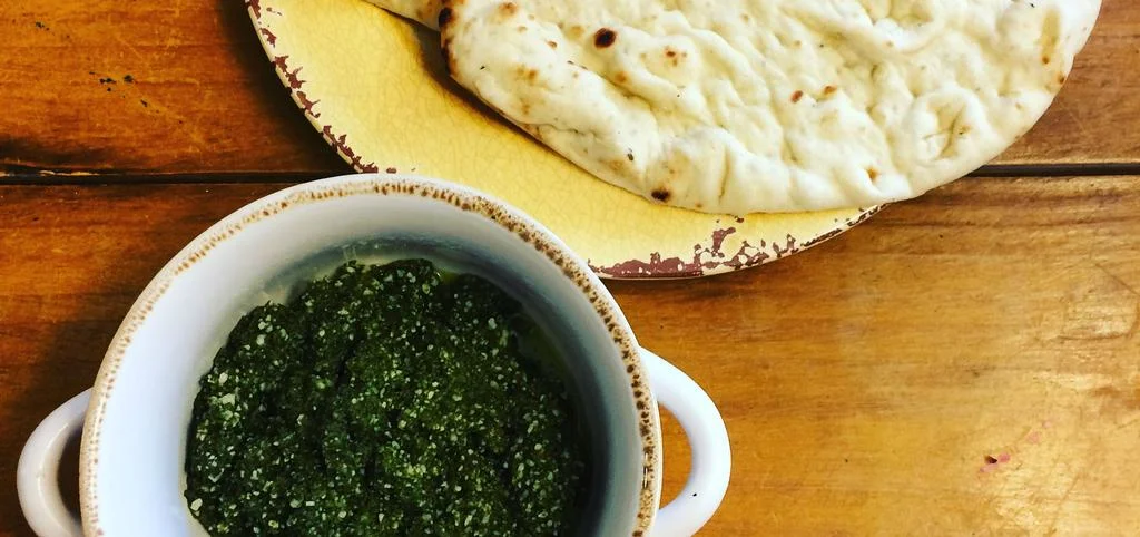 Peanut & Basil Pesto Created by Caroline Young Bearden, MS, RD, LD There’s nothing like freshly homemade pesto. Though its traditionally made with pine nuts and olive oil, I put a fresh and even more delicious spin on the Italian classic with peanuts and green peanut oil. . Serve it on top of bread, pizza and pasta. Ingredients 2 cups packed fresh basil leaves 2 cloves garlic 1/4 cup peanuts 2/3 cup green peanut oil pinch of salt pepper to taste 1/2 cup freshly grated Pecorino cheese 10 minutes 6 - Serving Size: 2.5 Tbsp Easy Directions Combine the basil, garlic and peanuts in a food processor and pulse until coarsely chopped. Add 1/2 cup of the oil and process until fully incorporated and smooth. Season with salt and pepper. If using immediately, add all the remaining oil and pulse until smooth. Transfer the pesto to a large serving bowl and mix in the cheese. Nutrition information per serving: Calories: 290 Calories from Fat: 270 Fat: 29g Trans fats: 0g Cholesterol: 0mg Carbohydrate: 5g Protein: 5g Fiber: <1g Sodium: 520mg