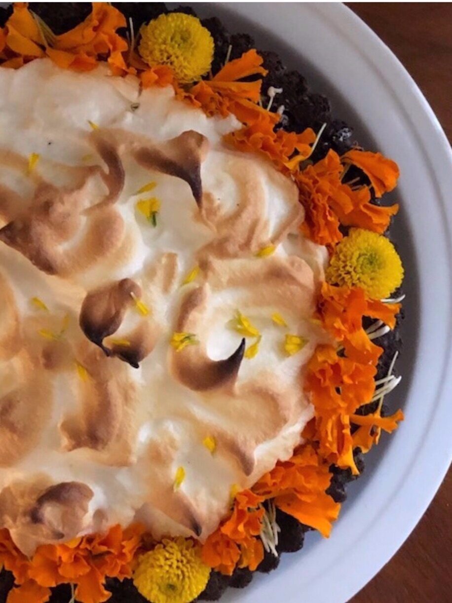 Add to your Day of the Dead party by finding a festive store bought chocolate and meringue tart and decorate it with traditional marigold flowers.