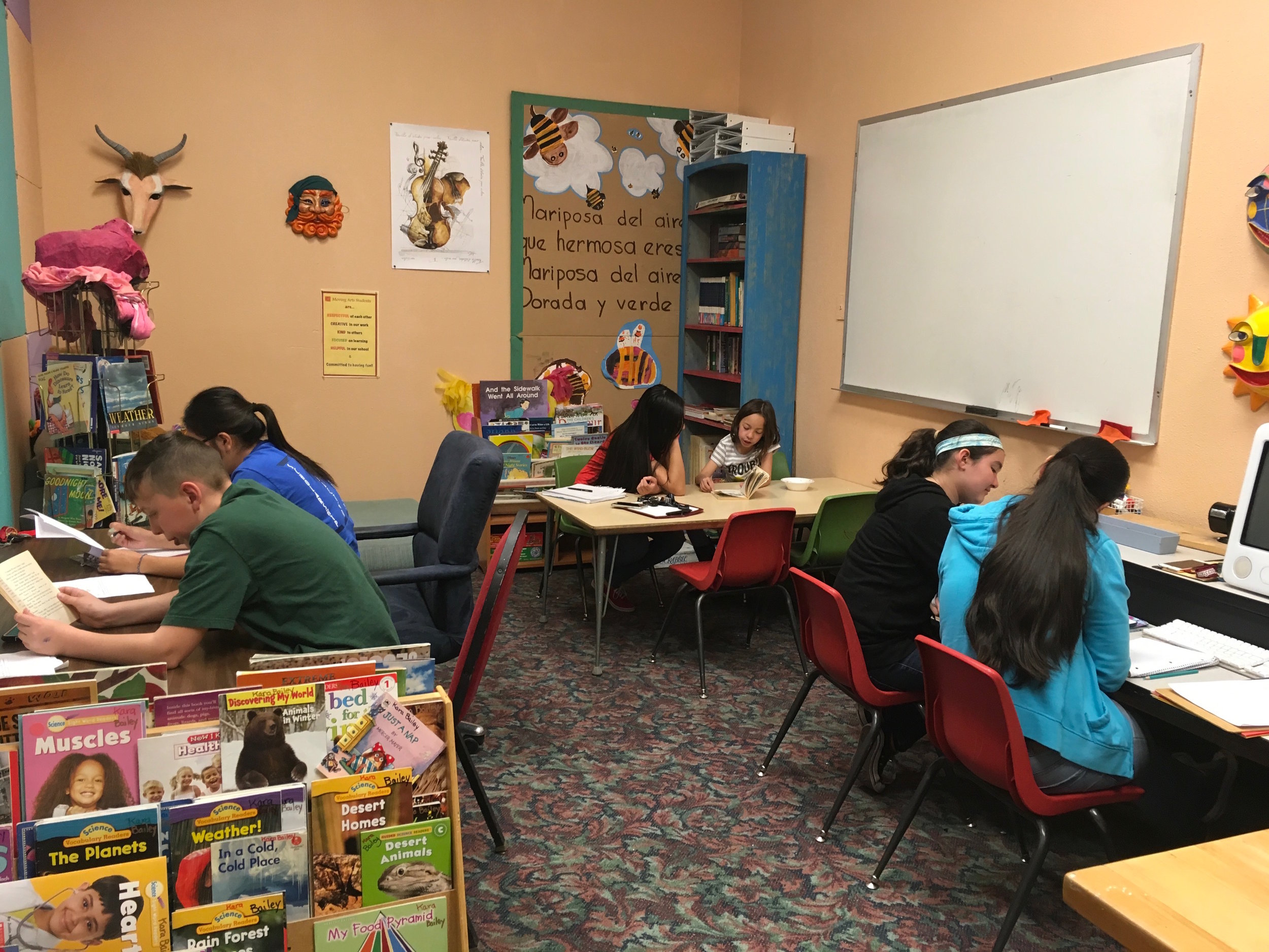 Peer Mentors working with students in the Moving Arts library