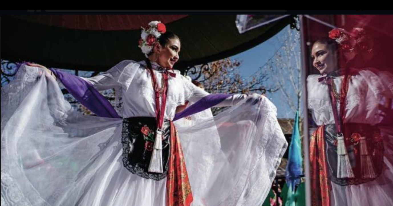 Barbara Garcia rehearses in a window front for the 2019 Women’s March in Santa Fe. Source: The Santa Fe New Mexican.