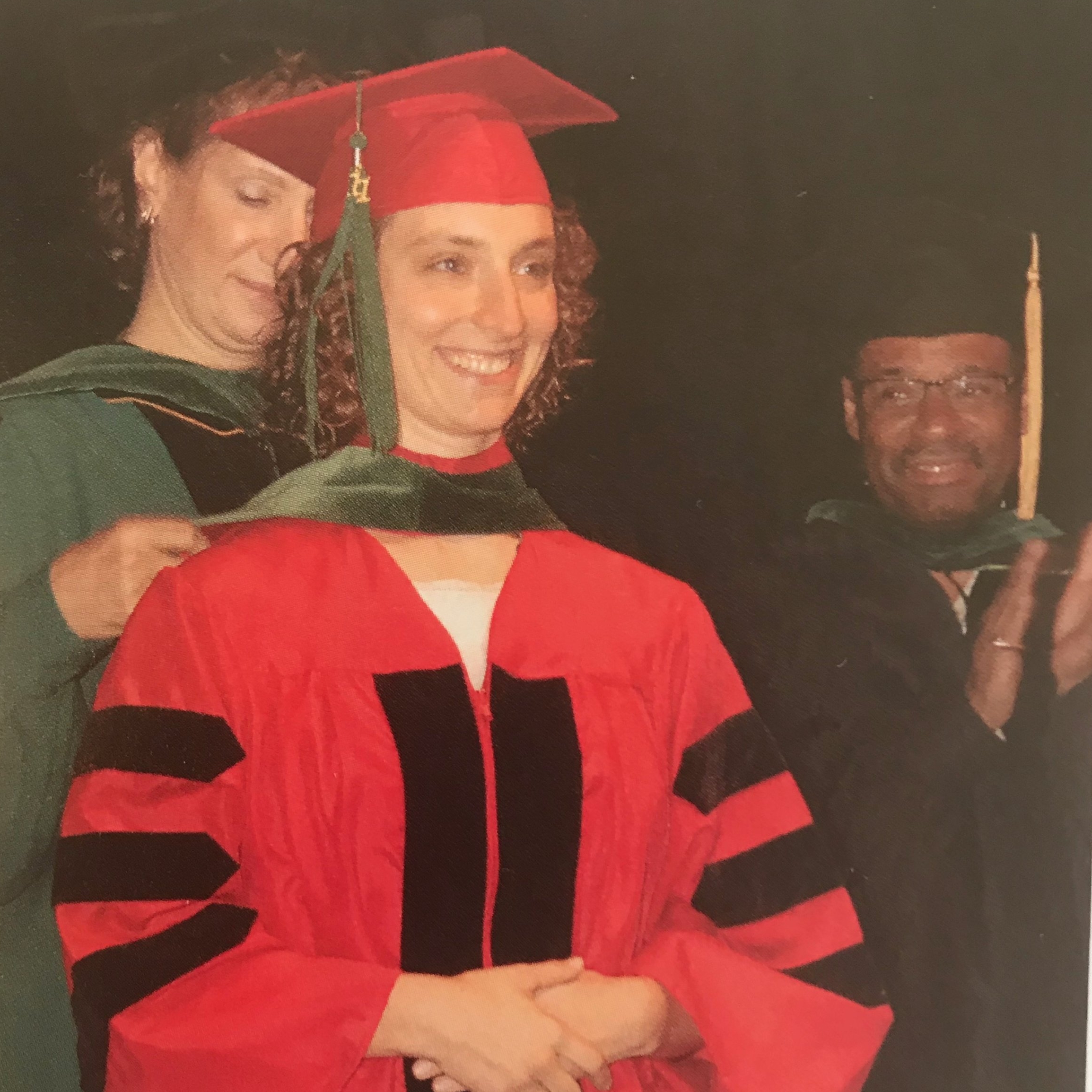 Dr. Glass in the classic green medical hood of graduation day 