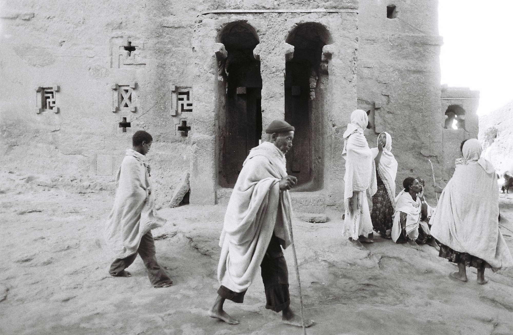 Pilgrims shrouded in traditional white woven cotton, walk barefoot great distances to pray among the sacred Churches during Orthodox Christmas. Many sleep on the ground outside entrance ways, or share camps in the surrounding area.