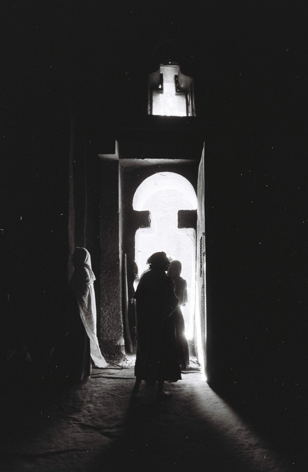  The interiors of these rock-hewn Churches are small and dimly lite. Pilgrims find a spot to sit on the floor to pray or sleep as a steady stream of devotees make offerings. 