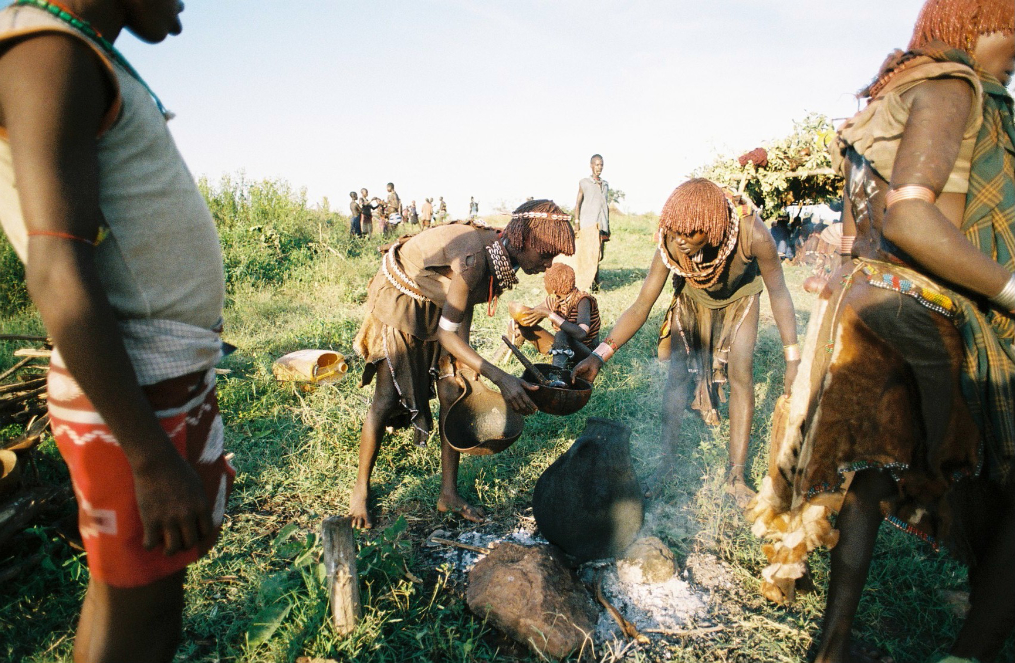  Women of the Hamar tribe prepare food in celebration of a traditional manhood ceremony. 