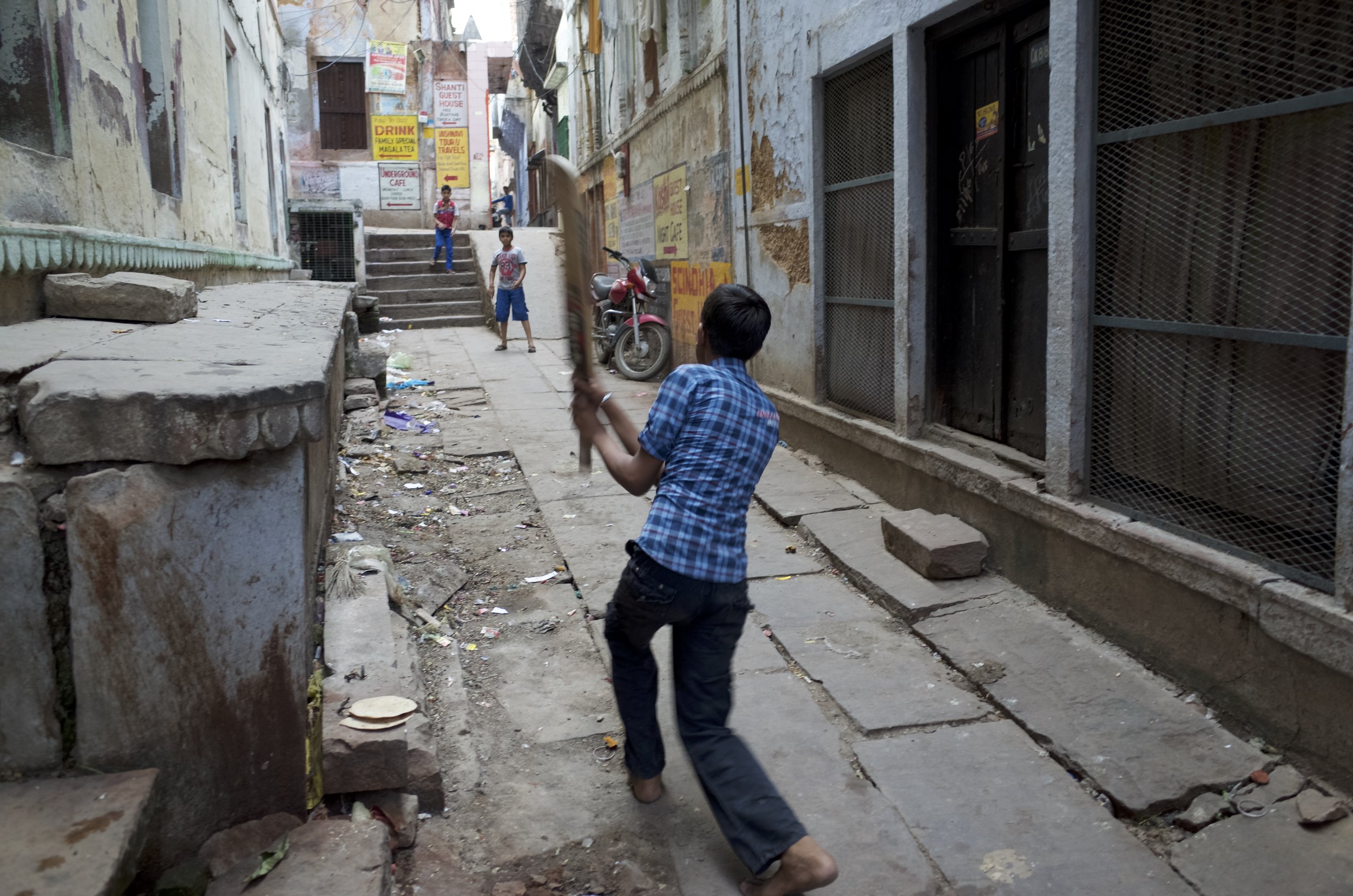 Boys play cricket along the narrow alley ways of Varanasi, India. Photo By: Sarah Tesla