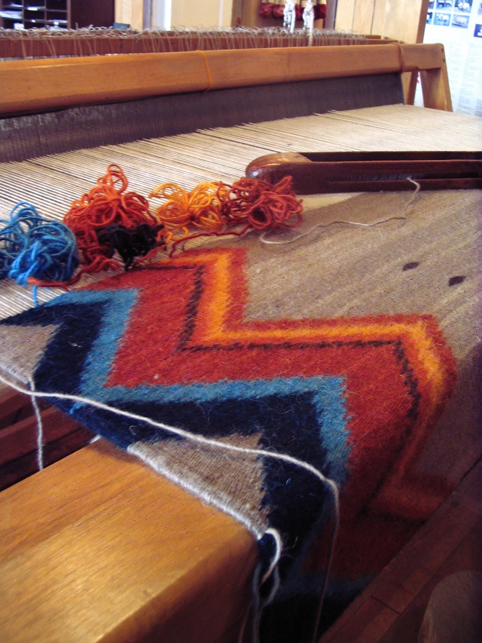 Weaving yarn threads into the warp to create a textile