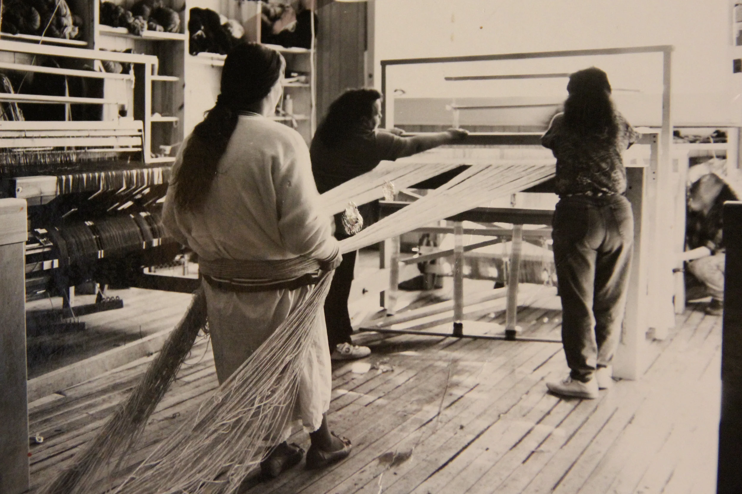 Tierra Wools weavers warp a loom in the 1980s