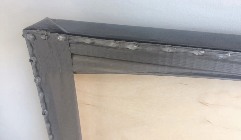 Figure 1: Taping duct tape to the backside of the panel so the hardened droplets can be easily removed once the resin is dry.