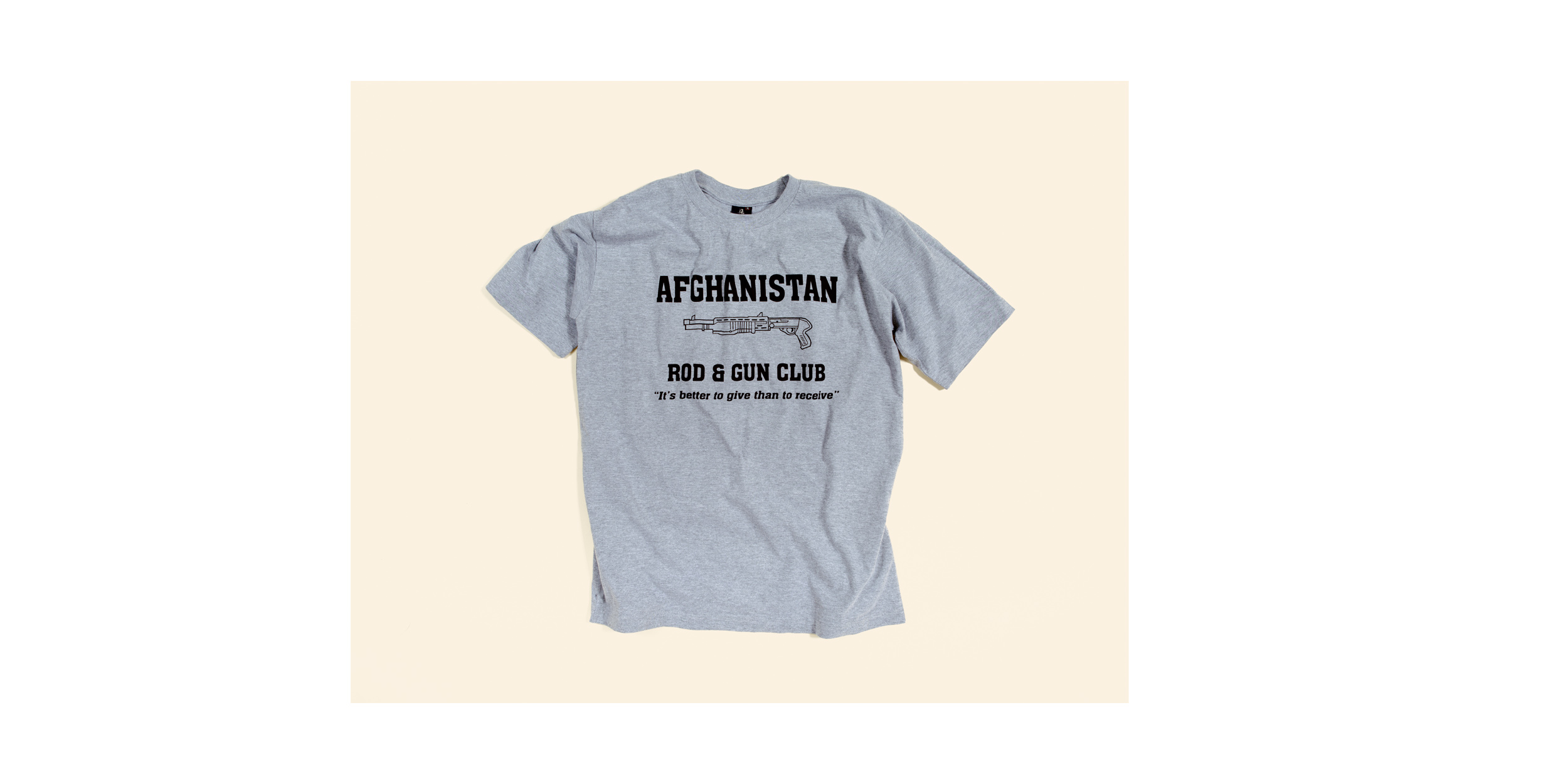  "Afghanistan Rod &amp; Gun Club - It’s better to give than to receive" T-shirt sold in a gift shop at "The Boardwalk", the social center of Kandahar Airfield, which offers Western style cafes, gift shops, restaurants and sports fields. The shirt has