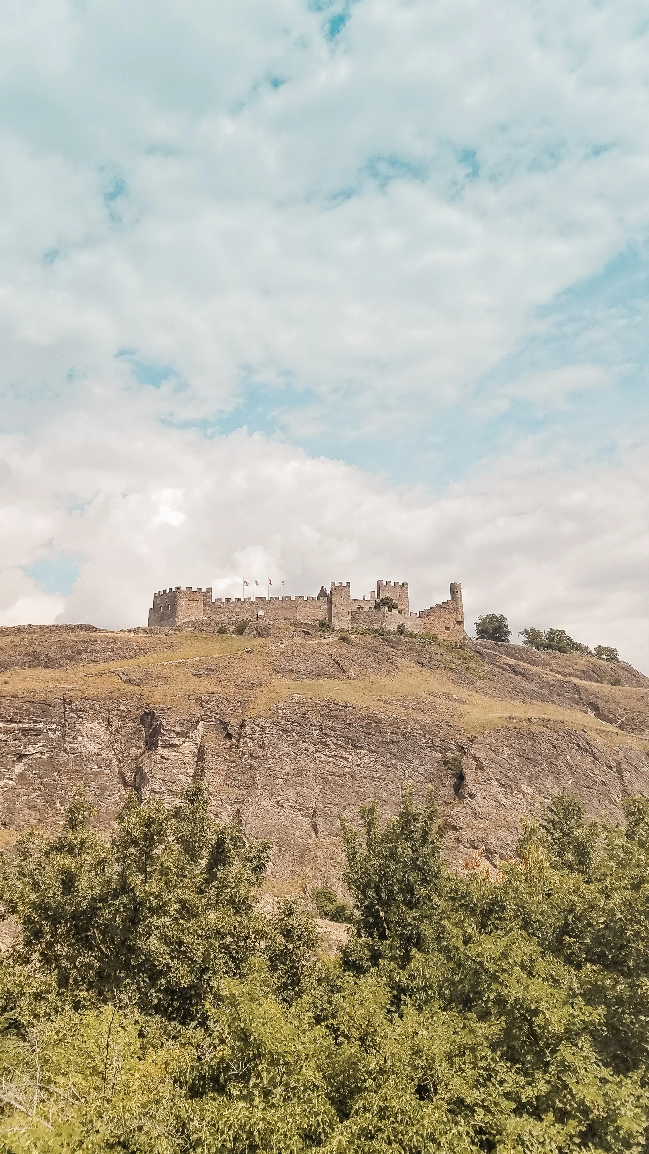 Tourbillon Castle in Sion can be seen from its neighboring chateau. You have to climb stairs uphill to reach either one, but the views are worth it. #Travel #Switzerland #Castle #Travelblogging #Lifestyle #TravelTip #swisscastle