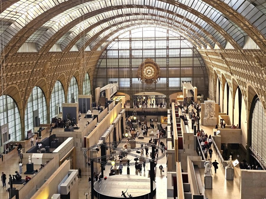 The inside of a museum with a hall full of sculptures in Paris
