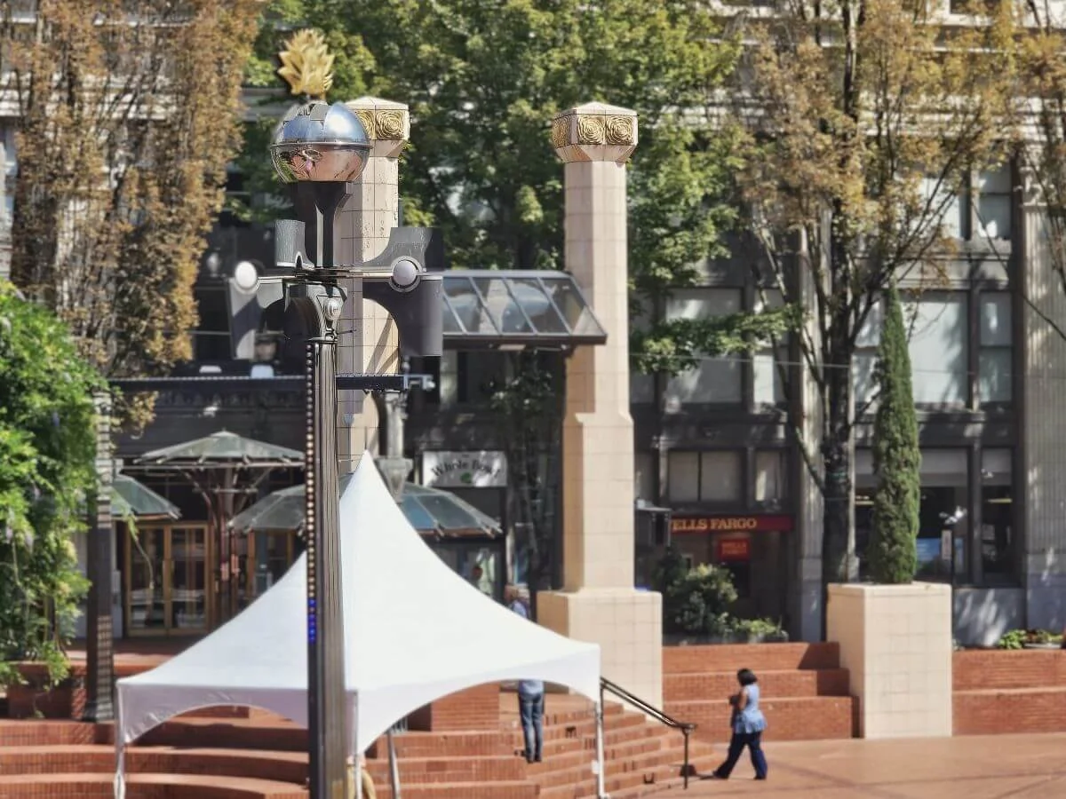 A square with a weather machine art piece in downtown Portland