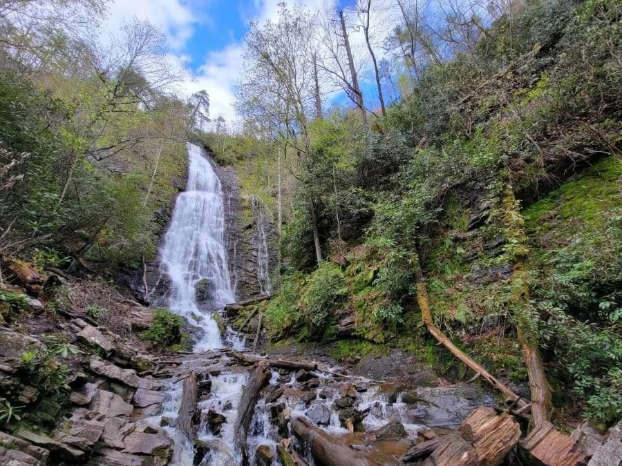 A waterfall surrounded by green on a Great Smoky Mountains national park solo trip.