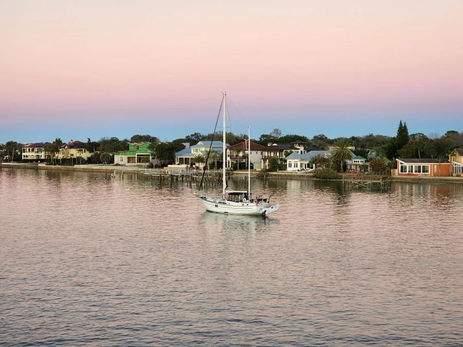 A boat under a pink sunset sky on a Florida girls trip in St. Augustine.